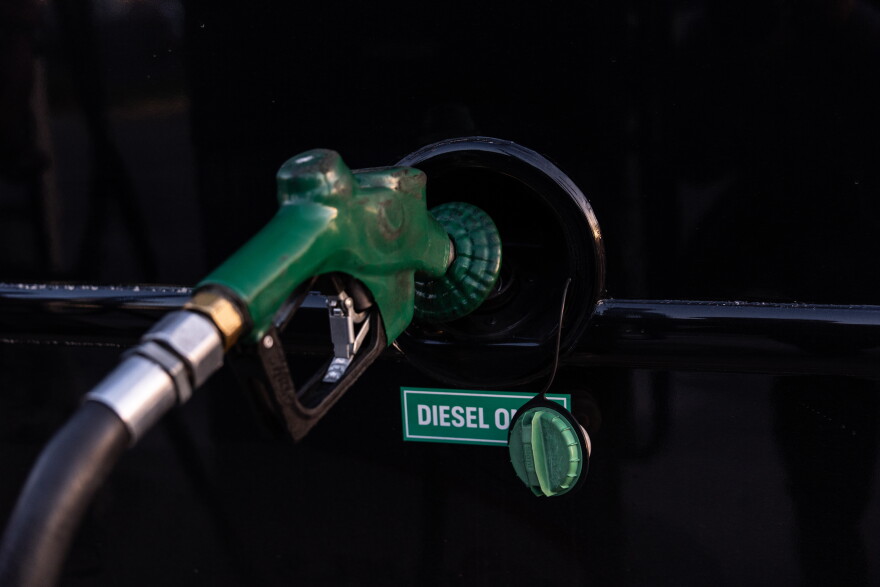 FILE - A nozzle pumps diesel into the fuel tank of bus.