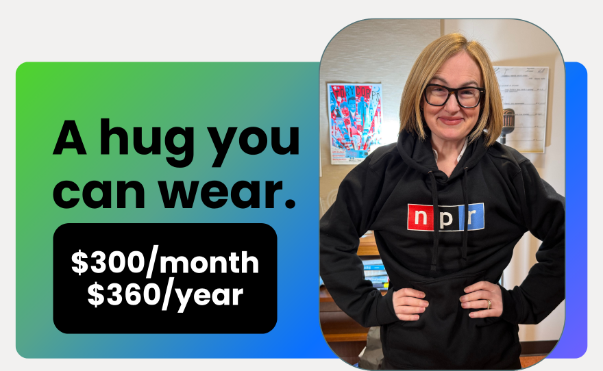 a white woman wears a dark gray sweatshirt with the NPR logo on it