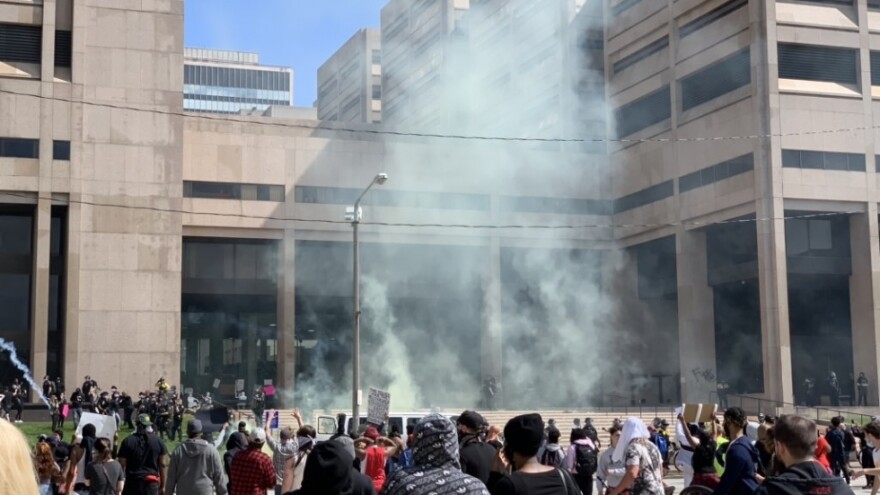 Law enforcement fires tear gas into the crowd gathered outside the Justice Center in Downtown Cleveland during protests against police brutality on May 30, 2020.