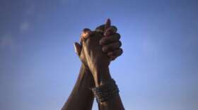 supporters-of-the-fatally-shot-michael-brown-hold-hands-in-solidarity-as-they-are-led-by-tracy-martin-father-of-trayvon-martin-at-the-the-peace-fest-rally-in-st-louis-on-sunday