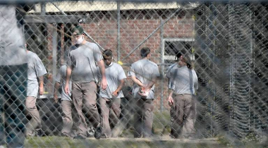 Inmates at Neuse Correctional Institution, in Goldsboro, move between buildings on Sunday.