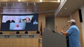 Yuma County resident Gary Skinner, right, speaks to Arizona Corporation Commission Chairman Nick Myers, upper left, at a public meeting on private water system concerns on Wednesday, Oct. 28, 2026 at the Yuma County Board of Supervisors Auditorium.