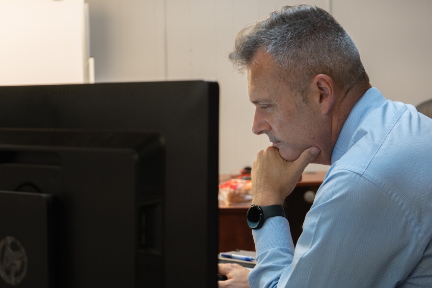 Cocke County Mayor Rob Mathis checks his inbox in his temporary office in a Newport, Tenn. strip mall on Monday, Sept. 8, 2025. After Hurricane Helene dealt irreparable damage to their courthouse and jail, Mathis and other county officials have been struggling to get FEMA to commit to funding a replacement.