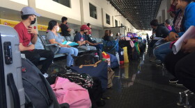 Passengers waiting to board the ferry that would transport them to Manilla. For travelers stranded in the Philippines, reaching Manilla meant the possibility of finding an international flight home. 