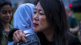 Po Murray, Chairman of the Newtown Action Alliance, embraces Mariam Azeez at the conclusion of a vigil in Newtown following the school shooting in Uvalde, TX.