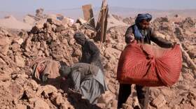 Afghan residents clear debris of damaged houses after earthquake in Nayeb Rafi village, Zendeh Jan district of Herat province on Oct. 10, 2023. (Mohsen Karimi/AFP via Getty Images)