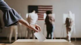 American casting her vote to a ballot box