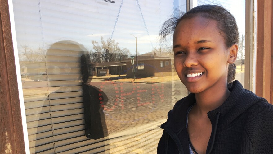 Ambiyo Farah, an 18-year-old Somali immigrant, standing by the now closed African Grocery in Liberal, Kansas.