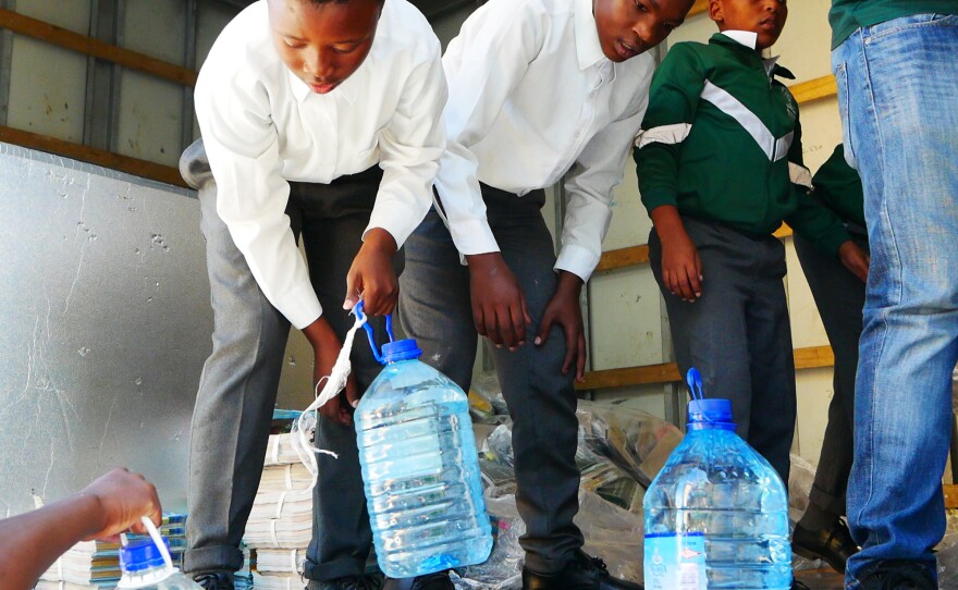 Schoolboys unload donated water at the Isikhokelo Primary School in Khayelitsha township. The principal shut off most taps to keep to tight water restrictions and has told students to bring their own water.