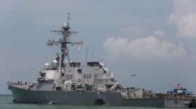 The guided-missile destroyer USS John S. McCain (DDG 56) is moored pier side at Changi naval base in Singapore following a collision with the merchant vessel Alnic MC Monday, Aug. 21, 2017. The USS John S. McCain was docked at Singapore's naval base with "significant damage" to its hull after an early morning collision with the Alnic MC as vessels from several nations searched Monday for missing U.S. sailors. (Grady T. Fontana/U.S. Navy photo via AP)