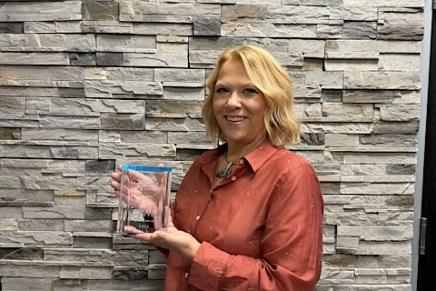 Ray City Auditor Ronda Rustad poses with the North Dakota League of Cities’ Leadership Excellence Award, which recognizes her public service, mentorship and advocacy for small communities.