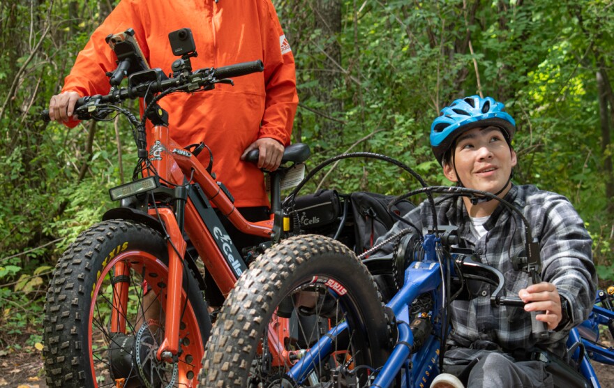 Mather Ling (right) gets ready to ride an adaptive mountain bike on Hog Hollow trail in Victor. Ling and his father, Peter, drove from Binghamton so he could use the bike offered by the town of Victor's parks and recreation dept.