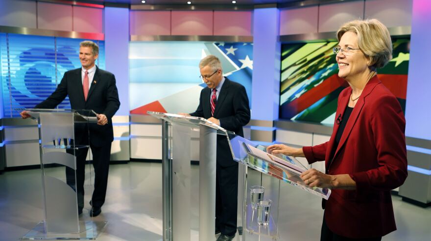 Massachusetts Republican Sen. Scott Brown (left) and Democratic challenger Elizabeth Warren before their first debate Thursday in Boston. At center is moderator Jon Keller.