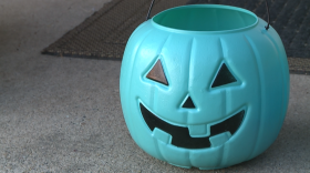 A teal colored pumpkin bucket