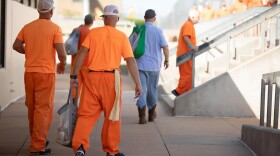 Prisoners move in a common area of the Joseph Harp Correctional Facility on Oct. 10, 2024.
