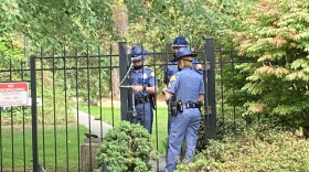  Washington State Patrol troopers use a chain to secure a gate at the governor's residence following a security breach on Wednesday, September 15, 2021. 