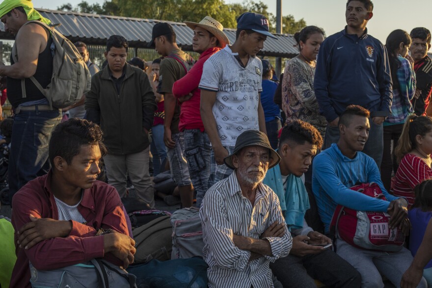 Central American migrants wait to cross into Mexico at Rodolfo Robles International Bridge in Tecun Uman, Guatemala, on Monday.