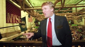 This June 7, 1995, file photo shows real estate magnate Donald Trump posing for photos above the floor of the New York Stock Exchange after taking his flagship Trump Plaza Casino public in New York City. Trump's business losses in 1995 were so large that they could have allowed him to avoid paying federal income taxes for as many as 18 years, according to records obtained by The New York Times. (Kathy Willens/AP)