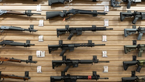 Rifles and shotguns are mounted on a wooden wall at Bristlecone Shooting, Training and Retail Center in Lakewood, Colorado.