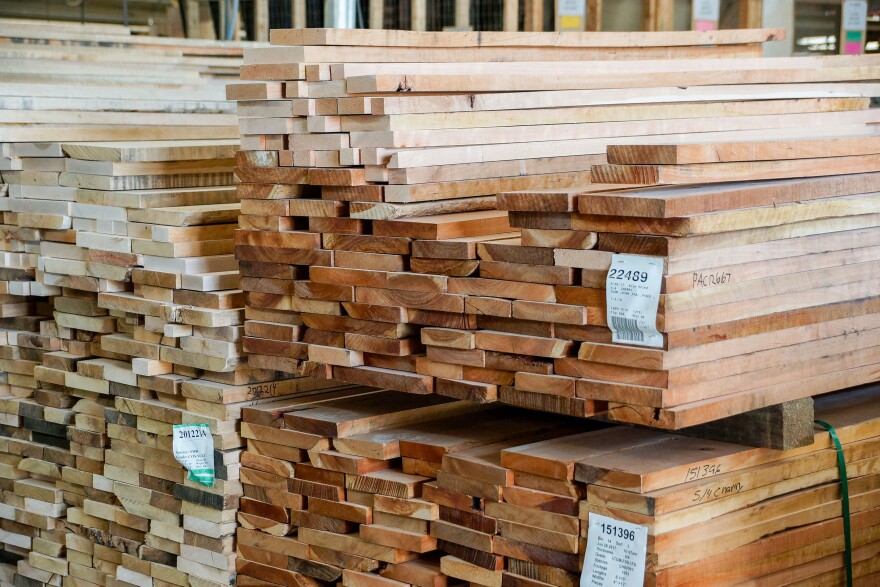 Dried lumber arrives at Gat Creek.  Workers sort through each board by hand.