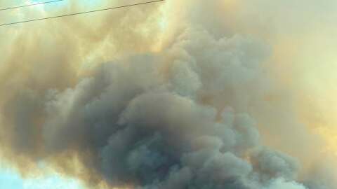 While the immediate threat to local homes has eased, authorities continue to monitor lingering hotspots and manage dense smoke spreading into neighboring coastal communities from separate blazes.