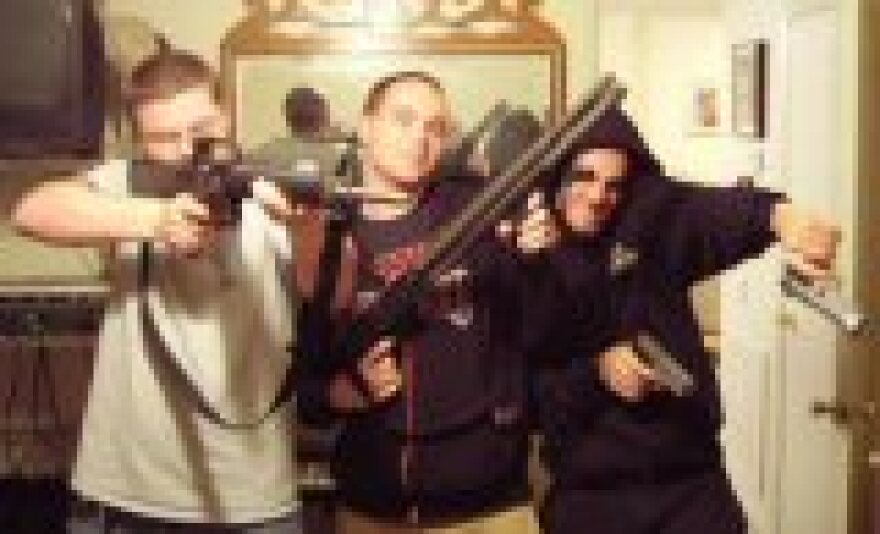 Second suspect Ryan David Mills in the center of photo attached to police warrant