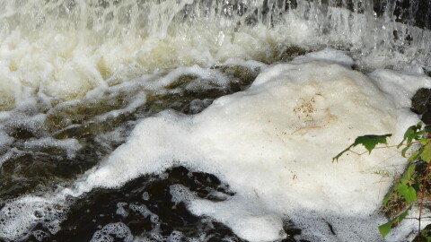 Foam caused by PFAS contamination at one of the many sites in the state where the "forever" chemicals have been found.