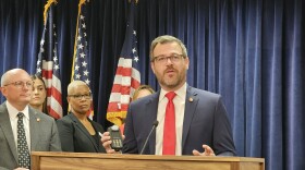 Rep. Mike Schietzelt, R-Wake, holds an ignition interlock device that's used to keep drunk drivers from starting their cars.