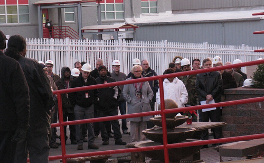 Some of the 100 employees who attended the dedication listen as an ABB co-worker remembers their colleagues.