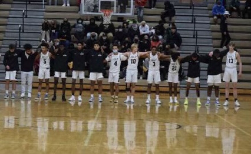 Ji’Ri Ash-Shakoor (#3) stands with his teammates prior to Holt’s game.