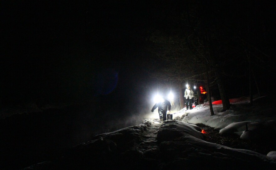 Samples are carried in buckets from the river to the field laboratory — a tent with a heater — where they can be inspected under a flashlight. (Photo: Ellie Katz/IPR News)