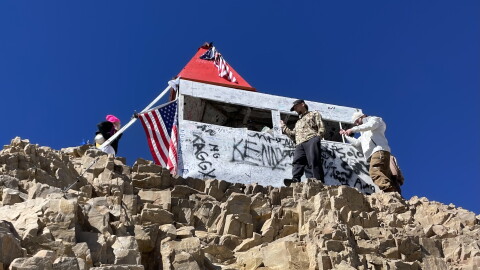 Hikers stand next to the hut at the top of Mount Timpanogos on Sept. 20, 2026.