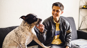 Barbara Grimm sits on her couch with her dog, Sadie Sue, a day before moving out of Pine Lake Apartments.