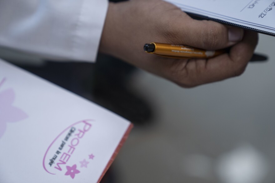 A doctor reviews a patient's medical form at the PROFEM clinic in Tijuana.