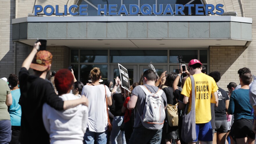 A group of protesters gather outside police headquarters following a verdict in the trial of former St. Louis police officer Jason Stockley on Sept. 15, 2017, in St. Louis. Stockley has been found not guilty in the 2011 killing of Lamar Smith following a high-speed chase.