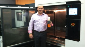 Matt Hlavin stands in front of a rapid prototyping and manufacturing machine. These can produce small batches of plastic products quickly and cheaply. This is the future, he says.