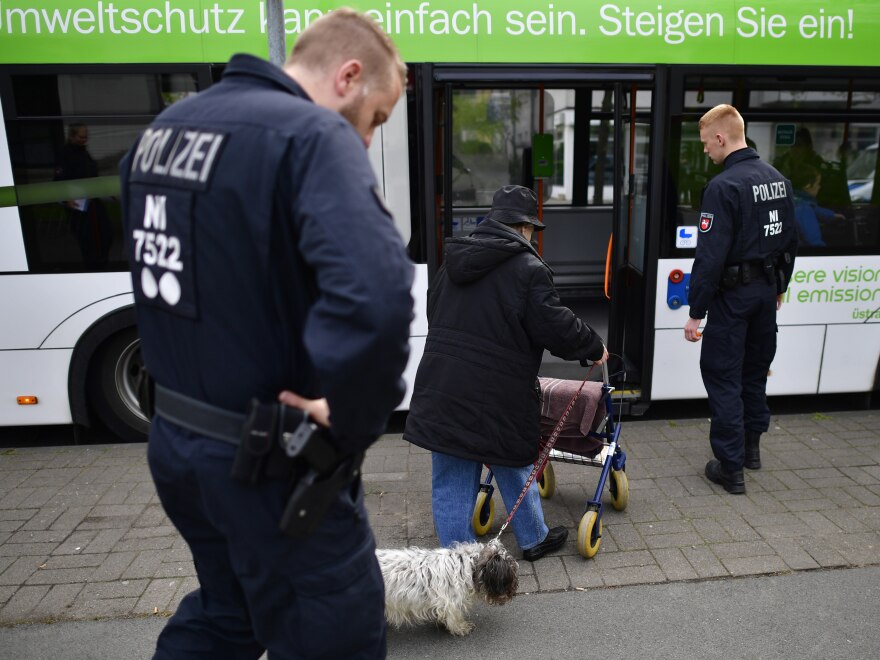 An elderly woman boards a bus and is helped by police forces to evacuate as part of the evacuation of 50,000 people on Sunday in Hanover, Germany.