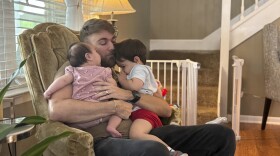 U.S. Marine Corps veteran Adrian Clouatre holds his 3-month-old daughter Lyn and his nearly two old son Noah at their home in Baton Rouge, La. on Tuesday, June 17, 2025. 