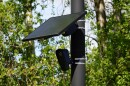 A Flock camera is mounted on a poll to help catch speeders.