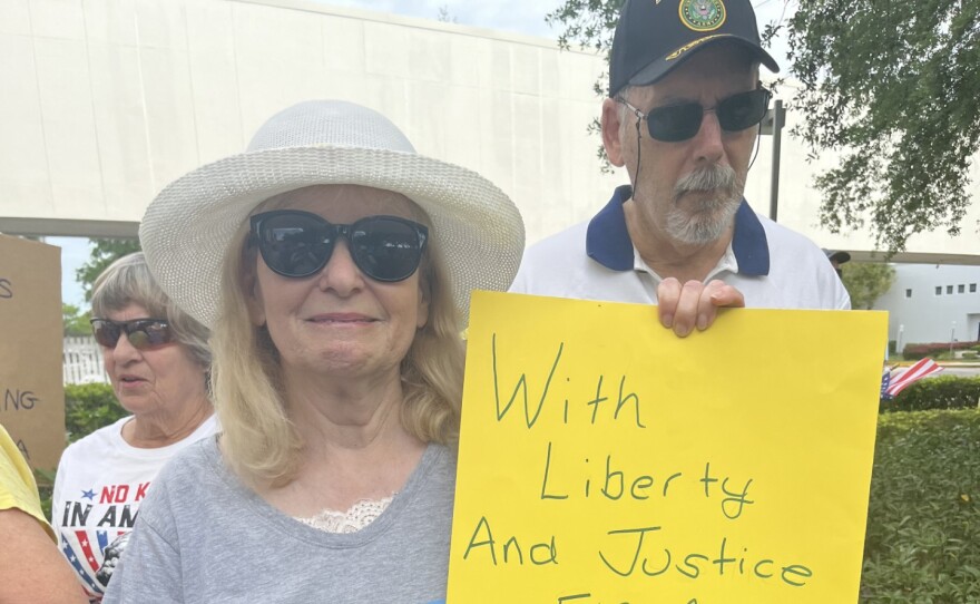 Ida Margolis of Naples displays a sign during the Collier County No Kings event.