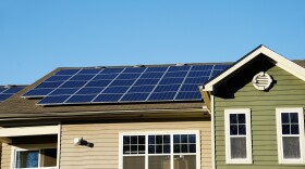 Solar panel installed on the roof of an apartment building.