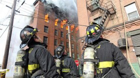 St. Louis firefighters check an adjoining building during a five-alarm fire in downtown St. Louis on Dec. 8, 2011. The six story, vacant building is a complete loss as 125 firefighters fought the stubborn blaze for five hours.