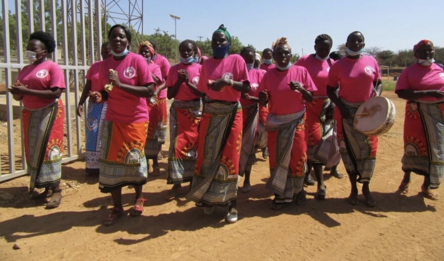 A group of women in Tharaka, Kenya dance and sing to send off a bike team before a fundraising ride.