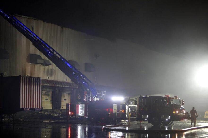 Firefighters work on cleanup after a fire ripped through a distribution center for the QVC home-shopping television network in Rocky Mount, N.C. on Saturday, Dec. 18, 2021. More than 300 employees were working at the facility when the fire was reported shortly after 2a.m. No injuries were immediately reported.