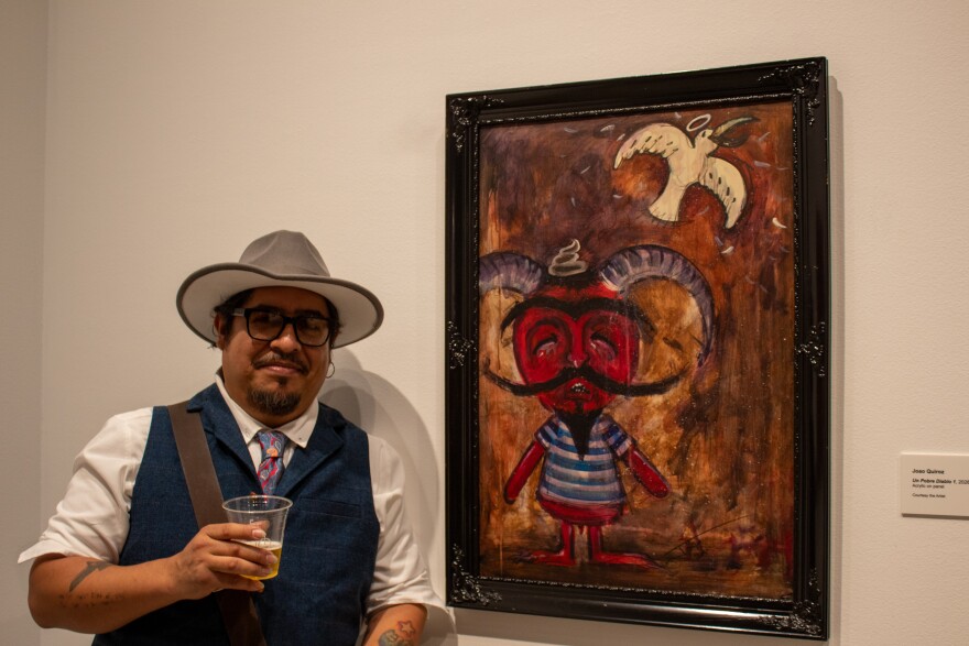 Angeles Salinas next to his art piece "Un Pobre Diablo 1."