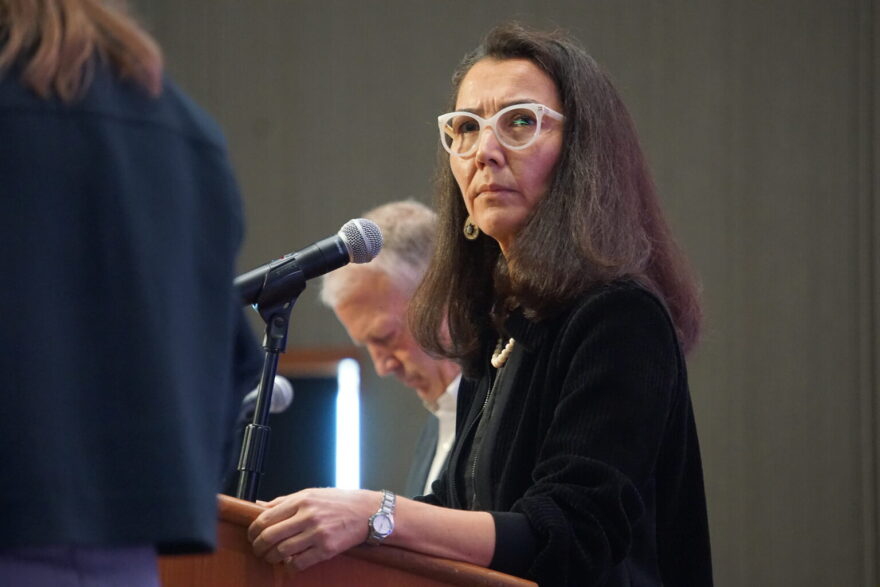 Mary Peltola listens to a question posed by moderator Michelle Egan at a candidate forum held by the Alaska Oii and Gas Association on Aug. 27, 2026. Next to Peltola is i Sen. Dan Sullivan. Peltola, a Democrat and former U.S. House member, is challenging Sullivan.