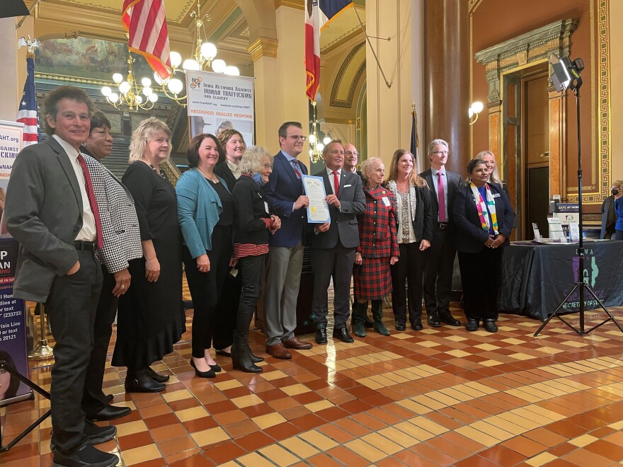 The Iowa Network Against Human Trafficking and Slavery stands with Lt. Gov. Adam Gregg and Secretary of State Paul Pate with the proclamation declaring January Slavery and Human Trafficking Prevention Month.