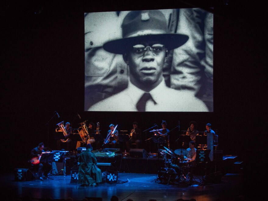 A photograph of jazz pianist James Reese Europe projected above the musicians performing Jason Moran's <em>James Reese Europe and the Absence of Ruin</em>.