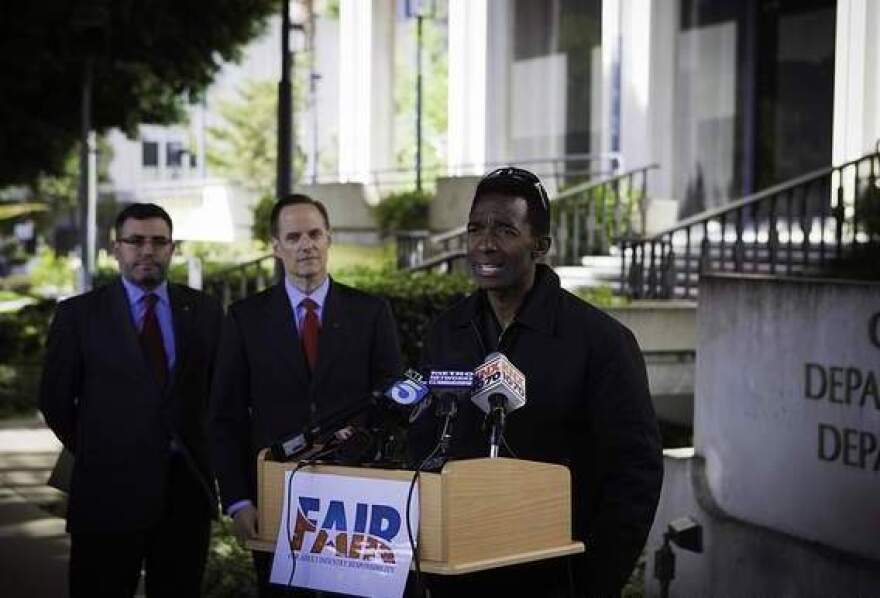 Former adult film star Darren James speaks about the policy of requiring adult film actors to use condoms, as Michael Weinstein (middle), head of the AIDS Healthcare Foundation, looks on.
