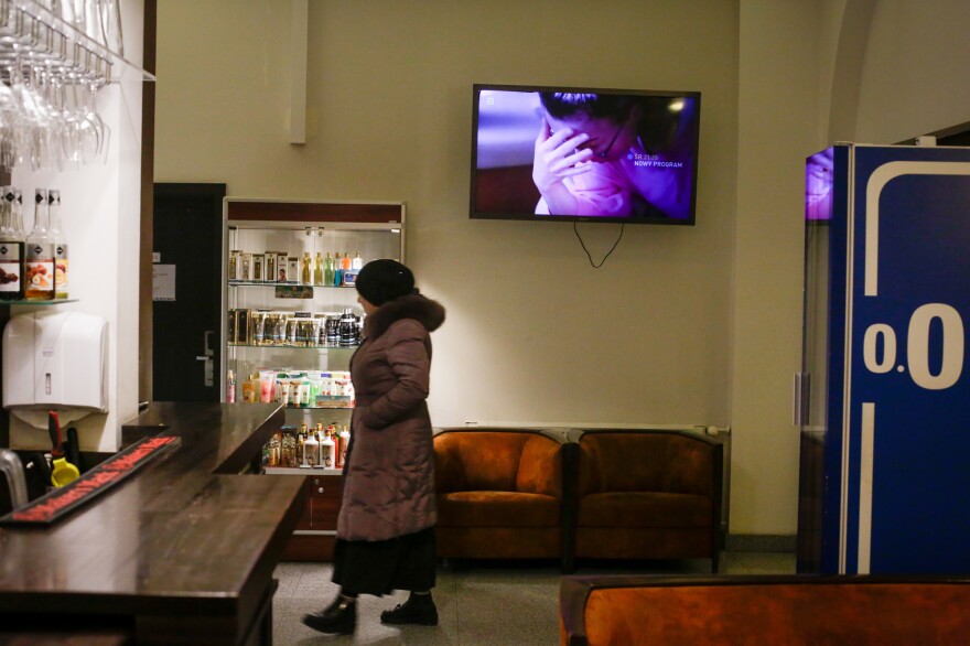 A refugee, recently arrived from Ukraine, walks the halls of the hotel.